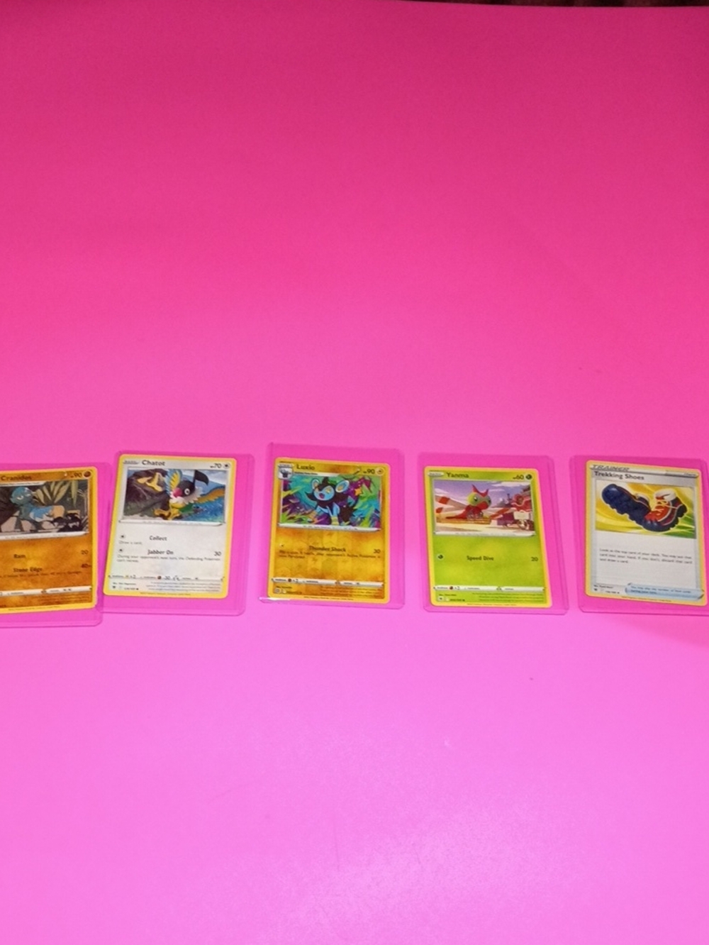 Five Pokémon Cards Displayed  Sleeves - Pink Background